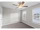 Bright bedroom with two windows, neutral paint, carpet, and a ceiling fan at 1029 Chaterly Ct, Riverdale, GA 30296