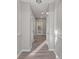 Bright and spacious hallway with hardwood floors and neutral walls with archways at 1029 Chaterly Ct, Riverdale, GA 30296