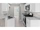 Modern kitchen with white cabinets, granite countertops, and stainless steel appliances at 1029 Chaterly Ct, Riverdale, GA 30296