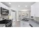 Modern kitchen featuring stainless steel appliances, granite countertops, and white cabinets at 1029 Chaterly Ct, Riverdale, GA 30296