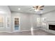 Spacious living room with fireplace, ceiling fan and access to the backyard at 1029 Chaterly Ct, Riverdale, GA 30296