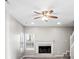 Cozy living room with a fireplace, hardwood floors, and lots of natural light from the windows at 1029 Chaterly Ct, Riverdale, GA 30296