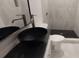Bathroom featuring dark granite countertop, vessel sink, and tiled walk-in shower at 1092 Hillcrest Se Dr, Atlanta, GA 30316