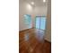 Bedroom with hardwood floors, high ceilings, a large window, and sliding door to the outside at 1092 Hillcrest Se Dr, Atlanta, GA 30316