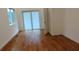 Bedroom view showing hardwood floors, white walls and trim, a window and sliding glass door at 1092 Hillcrest Se Dr, Atlanta, GA 30316