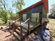 Home exterior featuring dark siding, wooden deck with metal railing, and a modern design at 1092 Hillcrest Se Dr, Atlanta, GA 30316