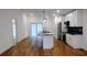 Bright kitchen features wooden floors, an island, stainless steel appliances, and white cabinets at 1092 Hillcrest Se Dr, Atlanta, GA 30316