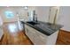 Kitchen island featuring granite countertop with stainless steel sink and white cabinets at 1092 Hillcrest Se Dr, Atlanta, GA 30316