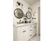 Well-lit bathroom featuring a double vanity with round mirrors and ample storage at 1608 Terry Mill Se Rd, Atlanta, GA 30316