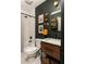 Cozy bathroom featuring a shower/tub combo, a modern vanity and rustic decor at 1608 Terry Mill Se Rd, Atlanta, GA 30316