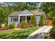 Charming home with a vibrant yellow door and beautifully landscaped front yard at 1608 Terry Mill Se Rd, Atlanta, GA 30316