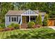 Charming home with manicured lawn, colorful flowerbeds, and a bright yellow door at 1608 Terry Mill Se Rd, Atlanta, GA 30316