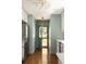 Stylish kitchen hallway with sage walls, stainless steel appliances, and an exterior door leading to the yard at 1608 Terry Mill Se Rd, Atlanta, GA 30316