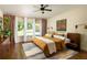 Comfortable main bedroom with ample natural light, ceiling fan, and stylish decor at 1608 Terry Mill Se Rd, Atlanta, GA 30316