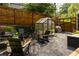Inviting backyard patio area with a greenhouse and comfortable seating for outdoor relaxation at 1608 Terry Mill Se Rd, Atlanta, GA 30316