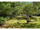 Serene backyard retreat with lush greenery, featuring multiple seating areas for relaxing and enjoying the outdoors at 2965 Pharr Court South Nw # 110, Atlanta, GA 30305