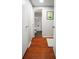Bathroom hallway with wood floors leading to the bathroom with toilet and shower/tub combination at 2965 Pharr Court South Nw # 110, Atlanta, GA 30305