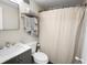 Bathroom featuring a vanity sink, toilet, and a shower/tub with a patterned shower curtain at 2965 Pharr Court South Nw # 110, Atlanta, GA 30305