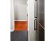 Hallway featuring contrasting wood and gray tile flooring, and stainless steel refrigerator at 2965 Pharr Court South Nw # 110, Atlanta, GA 30305