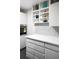 Modern kitchen design featuring sleek white cabinets, subway tile backsplash, and open shelving for decor at 2965 Pharr Court South Nw # 110, Atlanta, GA 30305