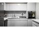 Sleek, white kitchen featuring stainless steel appliances, modern cabinetry, and a subway tile backsplash at 2965 Pharr Court South Nw # 110, Atlanta, GA 30305