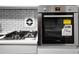 Close-up on the modern gas range with a Bosch oven and a clean white backsplash at 2965 Pharr Court South Nw # 110, Atlanta, GA 30305