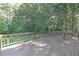 Spacious wooden deck with railings overlooks the backyard and wooded area at 304 N Briar Rdg, Woodstock, GA 30189