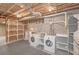 Basement laundry area features washer/dryer hookups, shelving and utility lines at 304 N Briar Rdg, Woodstock, GA 30189
