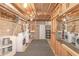 Unfinished basement laundry area features washer/dryer hookups and shelving at 304 N Briar Rdg, Woodstock, GA 30189