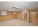 Carpeted basement features paneled walls, blinds, and a drop ceiling with lighting at 304 N Briar Rdg, Woodstock, GA 30189