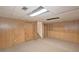 Unfinished basement with paneled walls, stairs, drop ceiling, and carpet floors at 304 N Briar Rdg, Woodstock, GA 30189