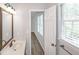Well-lit bathroom featuring a white sink, wood cabinets and large framed mirror at 304 N Briar Rdg, Woodstock, GA 30189