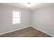 Bedroom with wood-look floors and natural light from a window at 304 N Briar Rdg, Woodstock, GA 30189