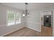 Dining area featuring modern lighting, trim detail and an adjacent kitchen at 304 N Briar Rdg, Woodstock, GA 30189