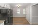 Bright kitchen area with wood floors, stainless steel refrigerator, and natural light at 304 N Briar Rdg, Woodstock, GA 30189