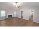 Bright living room with wood flooring, vaulted ceiling, fireplace and neutral paint at 304 N Briar Rdg, Woodstock, GA 30189