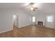 Bright living room with wood flooring, vaulted ceiling, fireplace and neutral paint at 304 N Briar Rdg, Woodstock, GA 30189