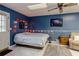 A cozy bedroom with an accent wall, queen bed, ceiling fan and shag rug at 873 Edgewater Cir, Marietta, GA 30062