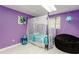 Charming bedroom featuring purple walls, a canopied bed, and a black beanbag chair at 873 Edgewater Cir, Marietta, GA 30062