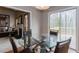 Bright dining area with glass table and sliding doors to the outdoor deck and living area with fireplace at 873 Edgewater Cir, Marietta, GA 30062