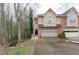 Inviting townhome showcasing a well-manicured lawn, attached garage, and neutral siding at 873 Edgewater Cir, Marietta, GA 30062