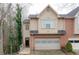 Two-story townhome with a brick and siding exterior, featuring an attached garage and manicured landscaping at 873 Edgewater Cir, Marietta, GA 30062