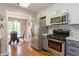 Charming kitchen boasts stainless appliances, gray cabinetry, and an adjacent dining area at 873 Edgewater Cir, Marietta, GA 30062