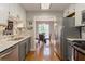 Stylish kitchen features stainless appliances, gray cabinetry, and an open dining area at 873 Edgewater Cir, Marietta, GA 30062