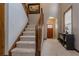 Carpeted staircase with wooden banister leading to the upper level of the home at 873 Edgewater Cir, Marietta, GA 30062