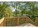 A lovely wooden back deck overlooks the green, tree-filled back yard at 2358 Larchwood Sw Rd, Atlanta, GA 30310