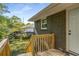 Wooden back deck features stairs to the yard and access to the home's back door at 2358 Larchwood Sw Rd, Atlanta, GA 30310