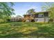 Spacious backyard view of a gray brick home with walkout basement at 2358 Larchwood Sw Rd, Atlanta, GA 30310