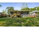 A view of the home's backyard and gray painted brick exterior at 2358 Larchwood Sw Rd, Atlanta, GA 30310