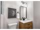Bathroom vanity with modern lighting, fixtures, and black framed mirror at 2358 Larchwood Sw Rd, Atlanta, GA 30310